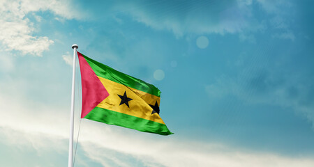 Waving Flag of Sao Tome and Principe in Blue Sky. The symbol of the state on wavy cotton fabric.