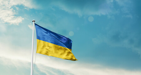Waving Flag of Ukraine in Blue Sky. The symbol of the state on wavy cotton fabric.