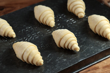 Fototapeta na wymiar Frozen Croissants on a Baking Dish in the Kitchen