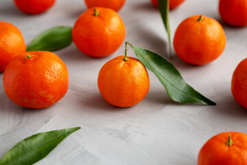 Raw Organic Mandarins on a gray background, side view. Close-up.