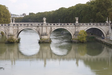 Fototapeta na wymiar Old bridge over Tiber river in Roma