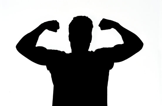 Man raising his arms making biceps and sign of victory and strengt