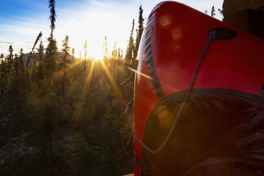 Alpacka Yak packraft resting against the porch of the Borealis-LeFevre cabin on Beaver Creek, National Wild and Scenic Rivers System, as the sun is setting in the summer over the White Mountains, just