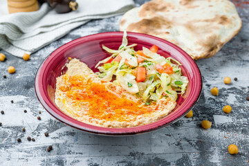 Traditional homemade hummus with pita on grey table