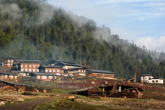 The sun illuminates the homes located in the Phobjika Valley.; Bhutan