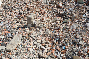 Pile of broken red bricks and fragments of concrete from destroyed building. Broken bricks close up...