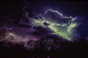 Lightning bolts illuminating a moody night sky; Nebraska, United States of America
