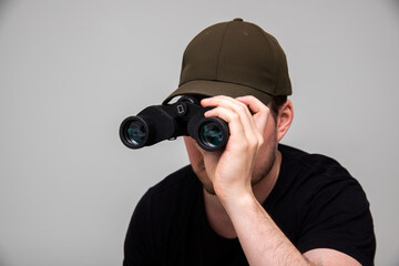 man using pair of binoculars