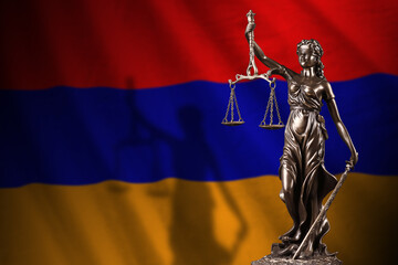 Armenia flag with statue of lady justice and judicial scales in dark room. Concept of judgement and...