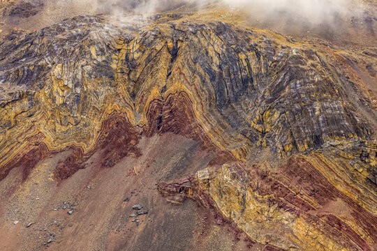 Sedimentary layers cover a mountainside.