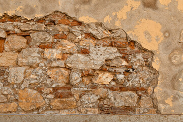 Close-up of an old stone and bricks wall with different textures and colors, Italy
