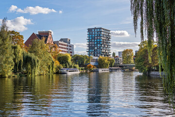 Schleswiger Ufer with an arch bridge Hansabruecke and the Oasis Tower in Berlin, Germany