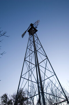 Low angle view of a wind vane against a blue sky; Princeton, Nebraska, United States of America