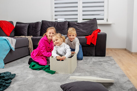 Three Children Are Having Fun In Room And Making Mess. Happy Childhood. Family Concept.