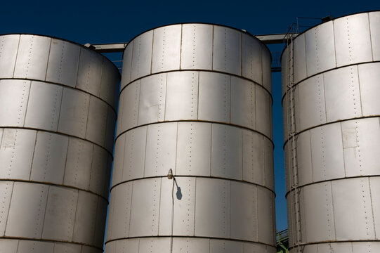 Grain bins and bright blue sky at the local grain elevator in Nebraska, USA; Brownville, Nebraska, United States of America