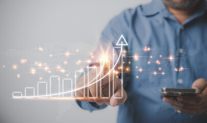 Businessman holding smartphones and touching on the arrow at growth graph virtual of business in the future. Business development to success for profit of corporation. Investment financial concept.