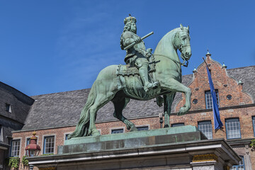 Fototapeta na wymiar Jan Wellem equestrian monument (1711) in front of Dusseldorf Town Hall (Altes Rathaus) at the Market square. Monument shows Jan Wellem dressed in full armor. DUSSELDORF, GERMANY.