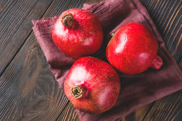 Fresh pomegranates on the wooden table
