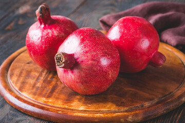 Fresh pomegranates on the wooden table