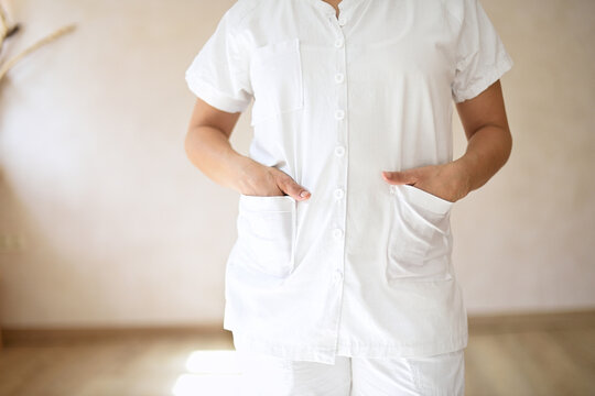 Medium Shot Of Woman In White Holistic Therapist's Work Uniform