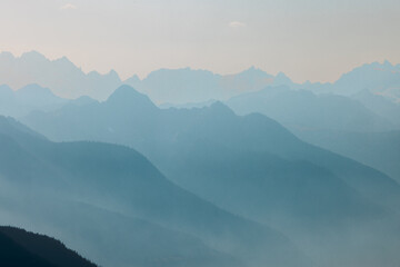 High mountain peak and range at the top of maple pass hike in north cascades national park in northern washington state united states of america with blue sky for copy space. Showing layers of blue.