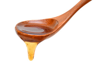 Honey dripping from a wooden honey dipper isolated on white background cutout
