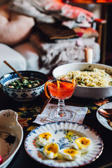 table full of food: eggs, pasta, mushrooms, beans, radishes, spring meal, cocktail