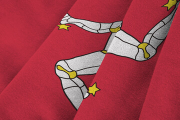 Isle of Man flag with big folds waving close up under the studio light indoors. The official...
