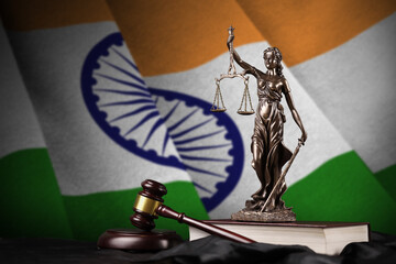 India flag with statue of lady justice, constitution and judge hammer on black drapery. Concept of...