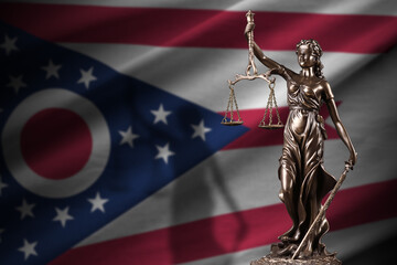 Ohio US state flag with statue of lady justice and judicial scales in dark room. Concept of...