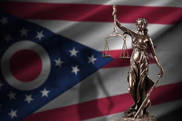 Fotobehang Ohio US state flag with statue of lady justice and judicial scales in dark room. Concept of judgement and punishment, background for jury topics © mehaniq41