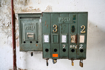 Old mailbox in the building. Rusty mailboxes on the wall. 