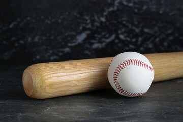 Baseball bat and ball on black background. Sports equipment
