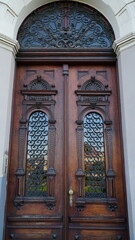 The rich decor decorates an entrance door of the old building of traditional architecture of in downtown.