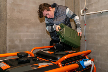 A young man pours gasoline into the gas tank of an electric generator. A technician maintains...