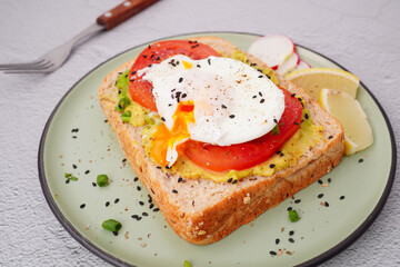 Breakfast, avocado on wholemeal bread and boiled egg on white background