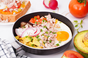 Breakfast fried eggs in a pan on a white background