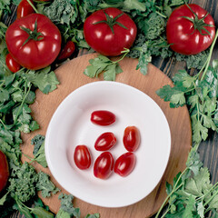 fresh red tomatoes on a white plate.