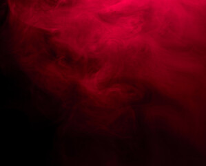 Abstract background of chaotically mixing puffs of red smoke on a dark background