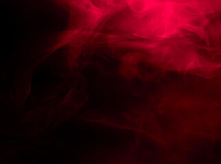 Abstract background of chaotically mixing puffs of red smoke on a dark background
