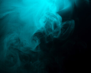 Abstract background of chaotically mixing clouds of turquoise smoke on a background of darkness
