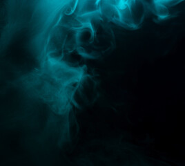 Abstract background of chaotically mixing clouds of turquoise smoke on a background of darkness