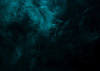 Abstract background of chaotically mixing clouds of turquoise smoke on a background of darkness