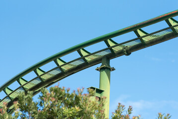 A roller coaster track painted in green