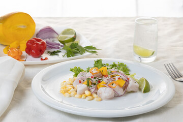 Ceviche, typical fish-based dish of Peruvian cuisine, along with the ingredients.