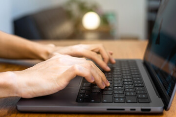 human hand image using and typing computer with circle lamp, sun light effect, laptop typing