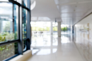 Abstract defocused blurred background of empty long corridor in the modern hospital - obrazy, fototapety, plakaty