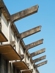 Concrete awning, old building in bright sky