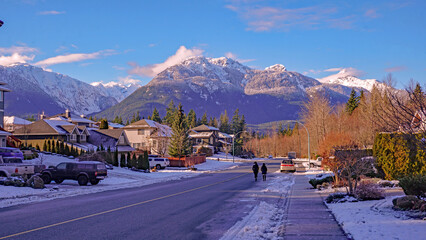 Winter walking in Garibaldi Highlands, Squamish, BC, with Garibaldi Mountain in background.