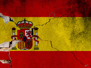 Spanish flag on cracked concrete wall
